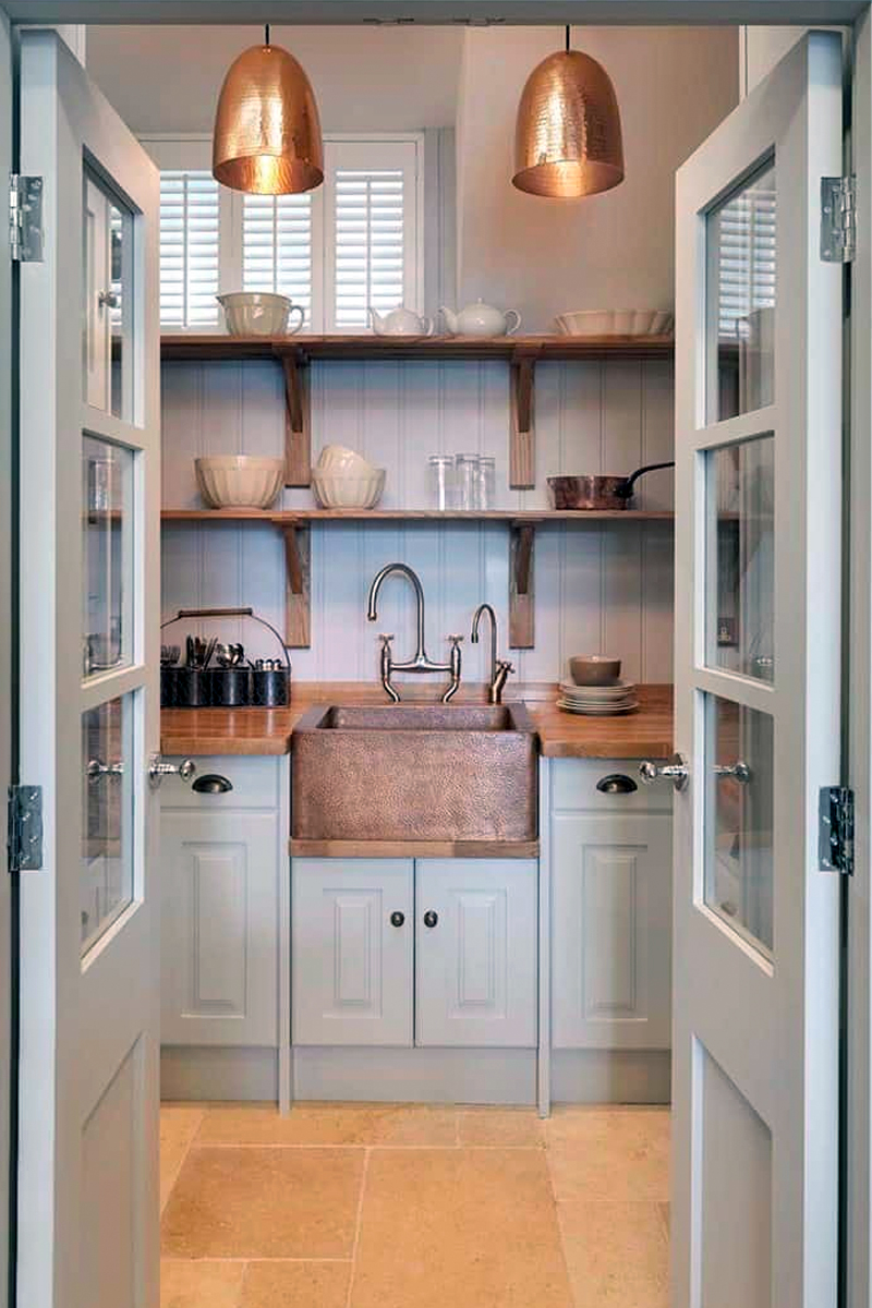 Butler's pantry with copper apron-front sink, white tongue-and-groove cladding and café plantation shutters. By John Lewis of Hungerford. Butler's pantry with copper apron-front sink, white tongue-and-groove cladding and café plantation shutters. By John Lewis of Hungerford.